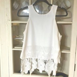 Cute tank with stitched floral underlay and zipper back.